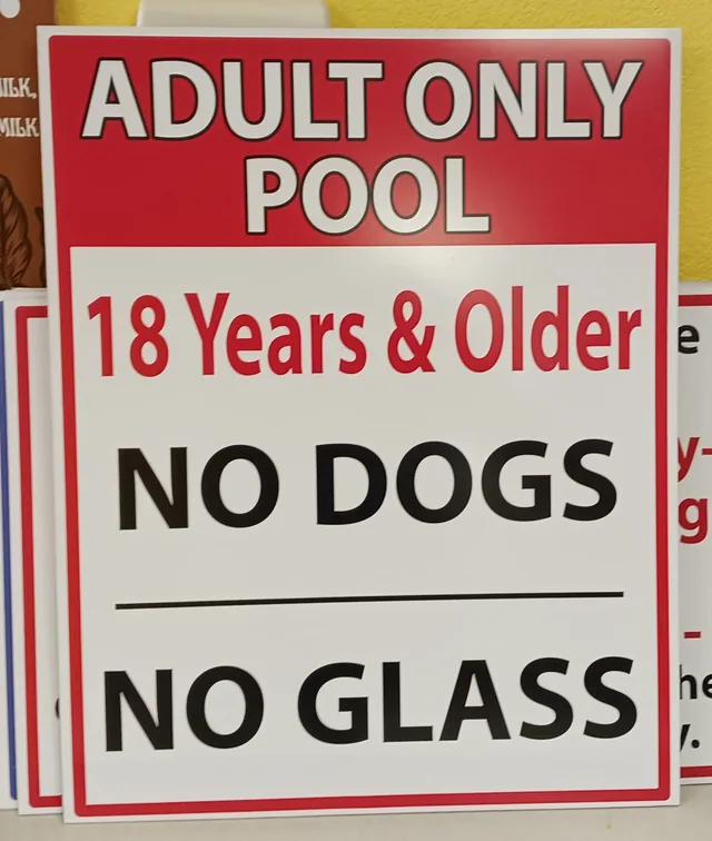 An adult-only pool sign with red and black lettering.
