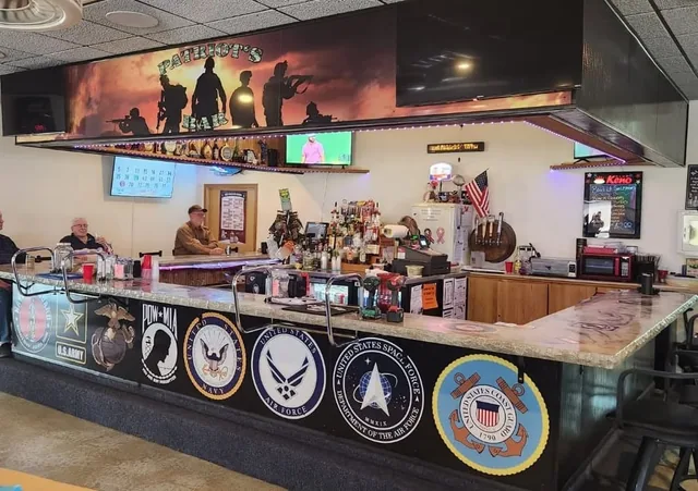 Military emblems printed along a bar front.