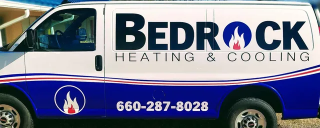 Van graphics with large side lettering and blue and red stripes.