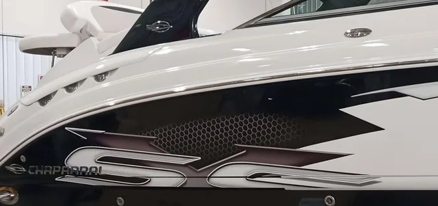 Gray and black graphics on the hull of a boat.