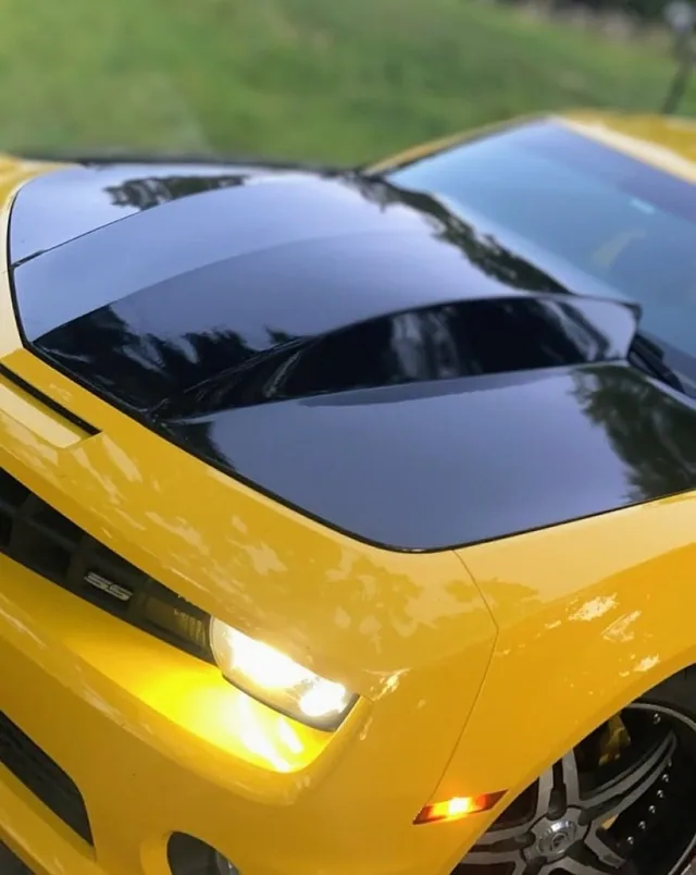 Black stripes on the hood of a yellow car.