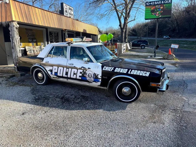 Black and white police graphics on a classic patrol car.