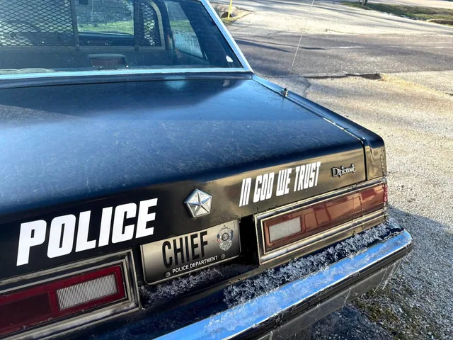 Rear lettering on a classic black and white patrol car.