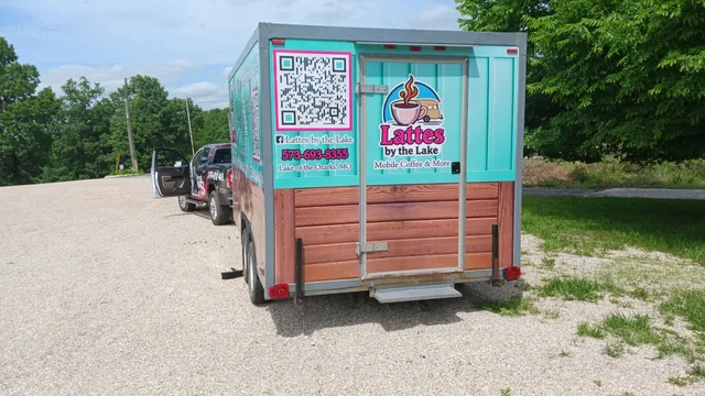 A coffee trailer with a wood-look wrap, seen from behind.