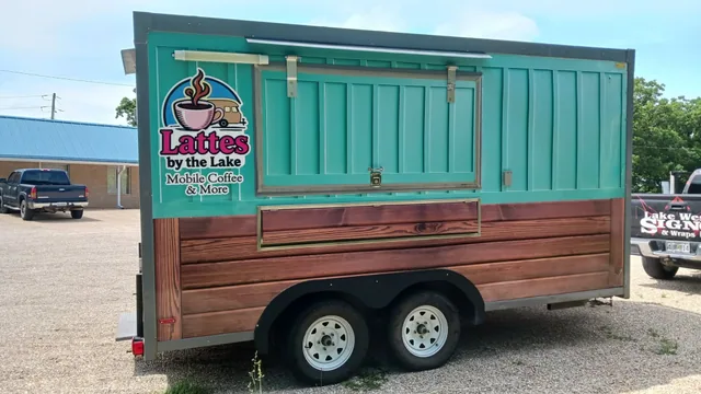 A coffee trailer with a wood-look wrap and a logo, seen from the side.