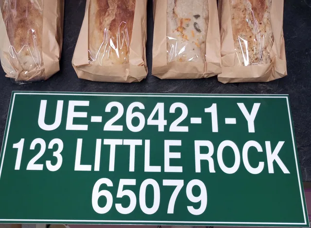 A green dock address sign with white lettering.