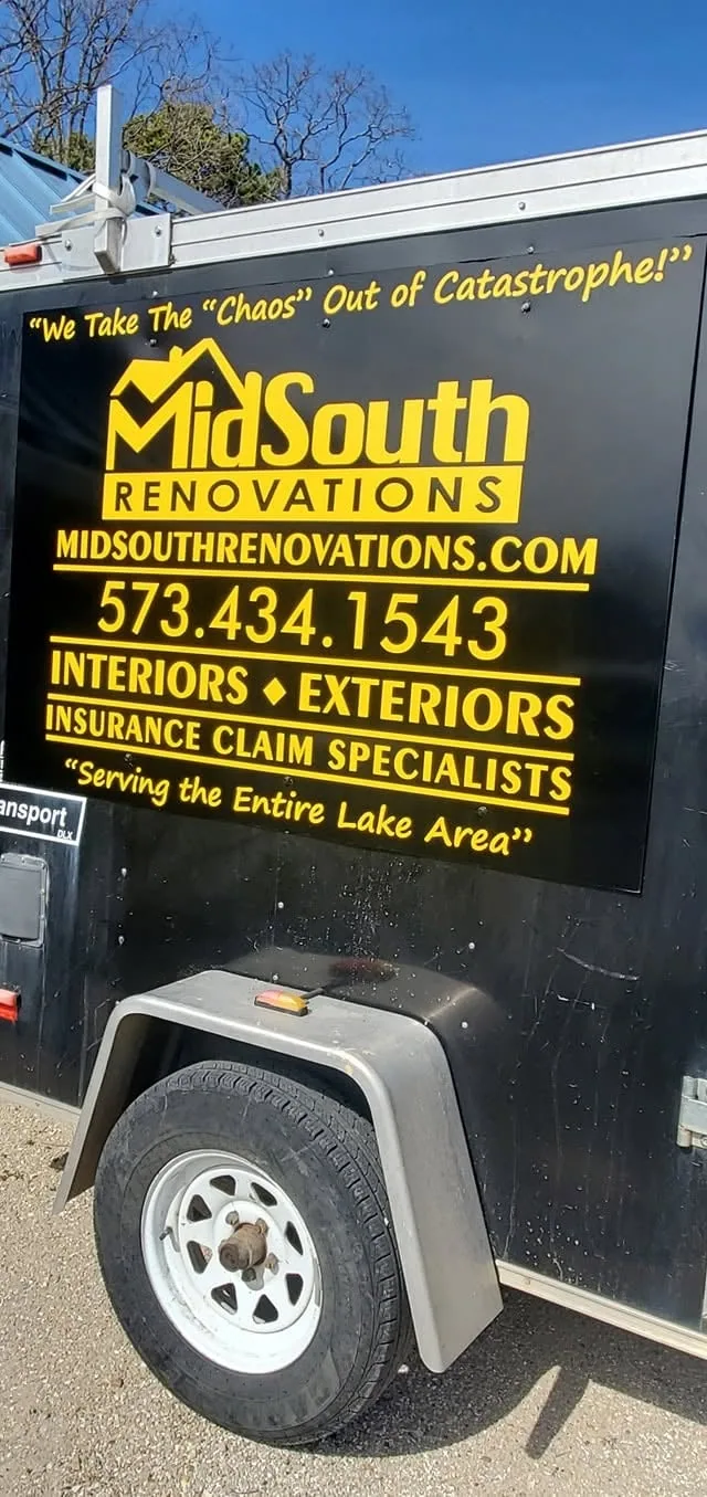 Yellow lettering and a logo on a black trailer.