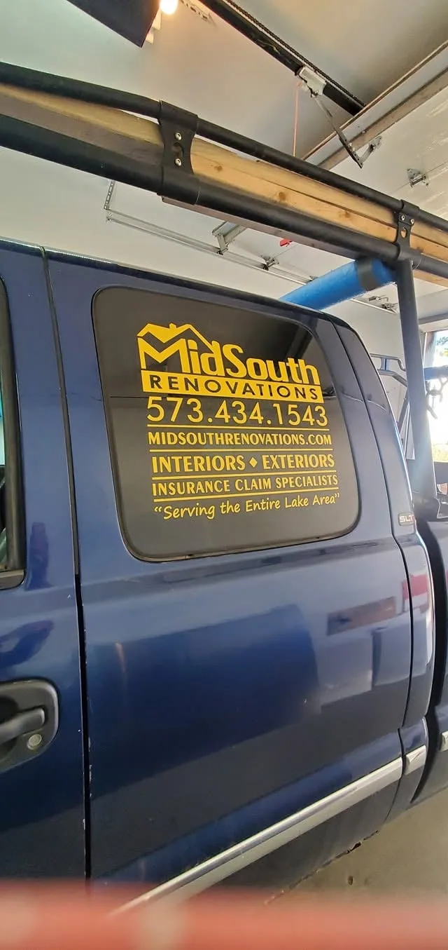 Rear window graphics with a logo on a blue pickup.