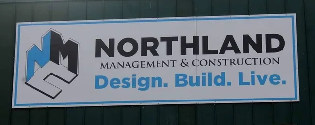 A wall-mounted business sign with a logo, seen straight on.