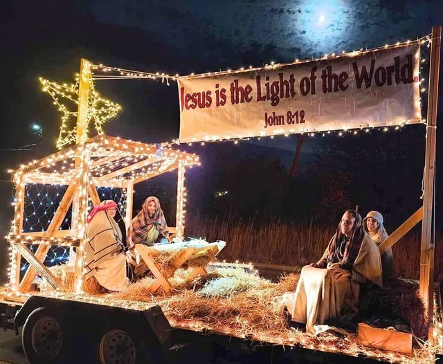 A printed banner on a lit parade float.