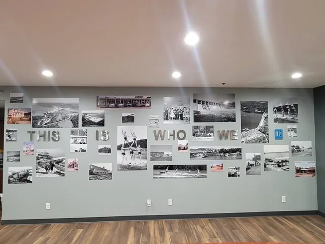 A wall of printed photographs and dimensional lettering.