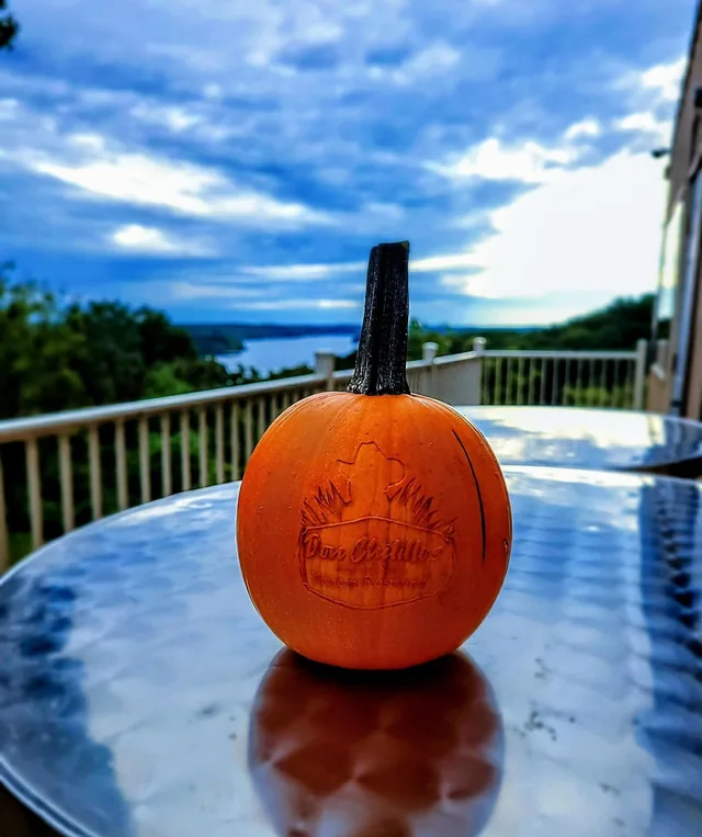 A pumpkin with an engraved design on a table.