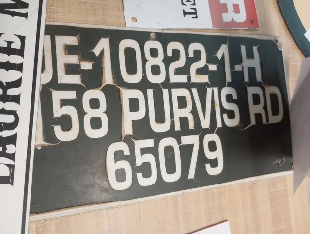 A black dock address sign with white lettering.