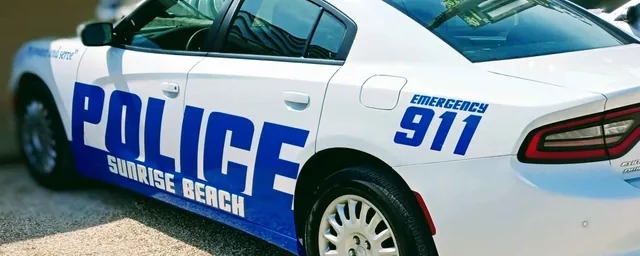 Blue police lettering on a white patrol car.