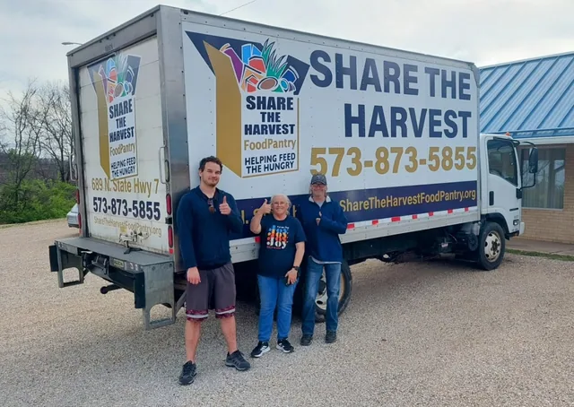 A box truck with lettering and graphics.