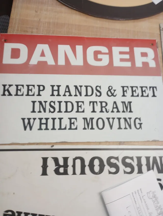 A danger sign with red and black lettering.