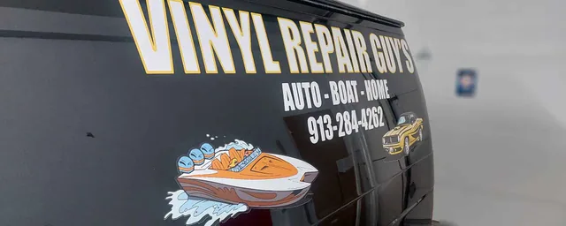 Lettering and an illustrated graphic on a dark van.